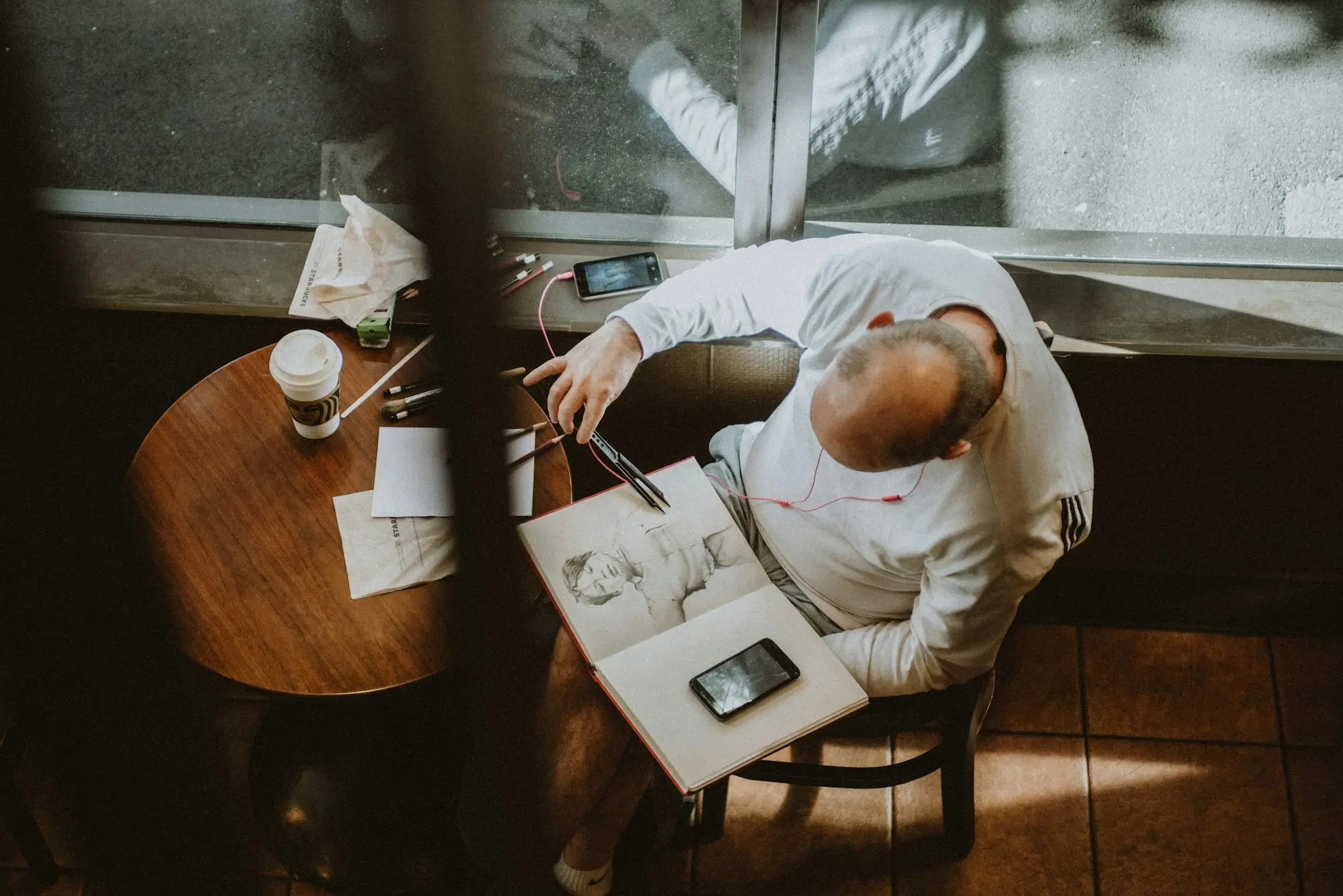Cafe owner in Auckland checking business funding options on a laptop at the counter