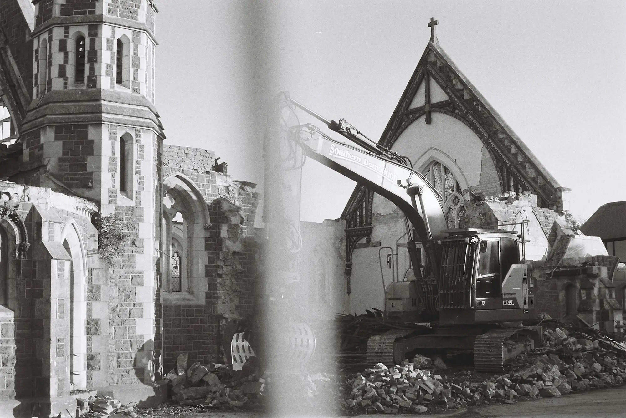 Builder loading timber onto a ute at a residential building site in Christchurch