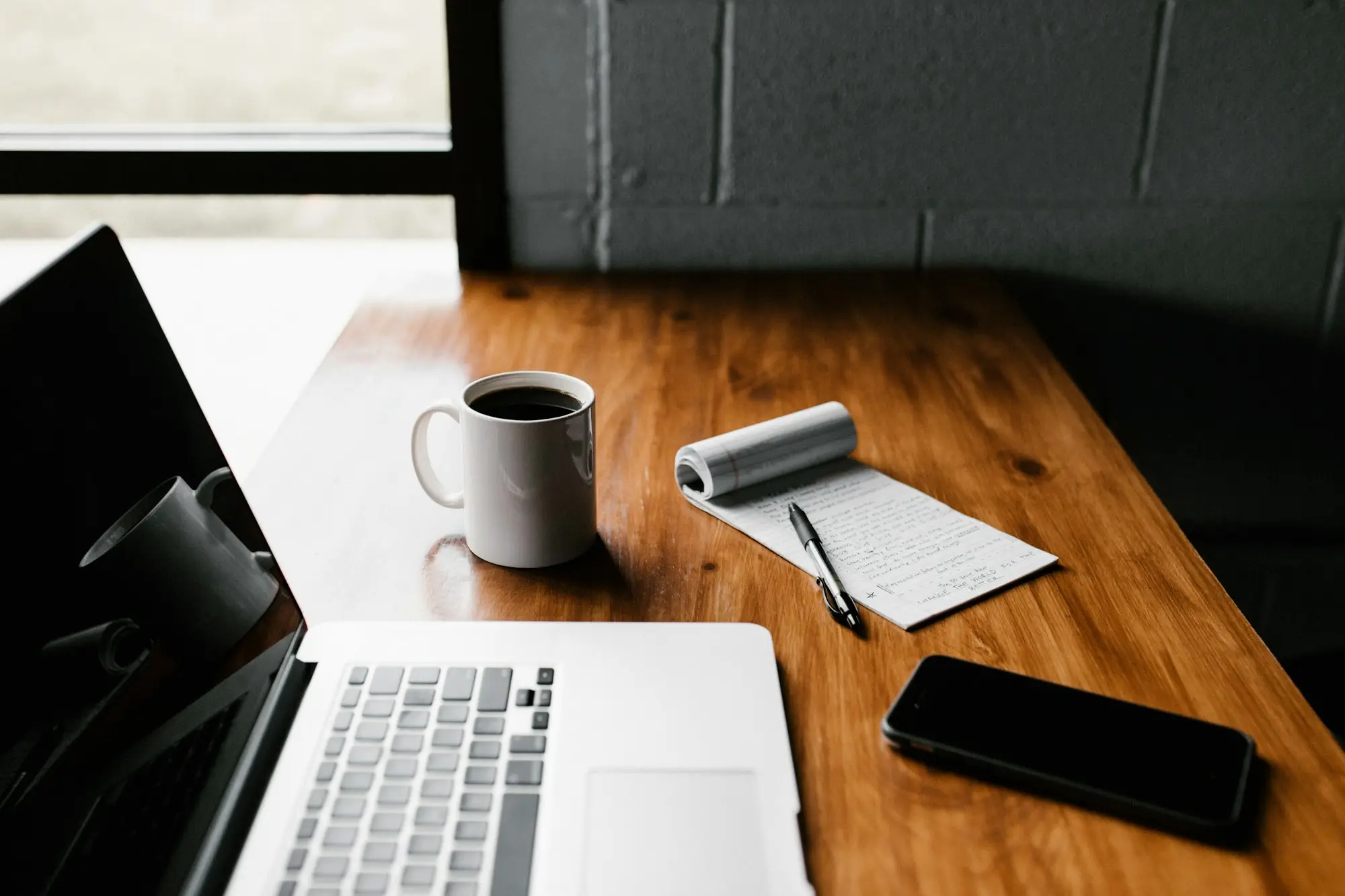 Business owner reviewing several loan statements spread on a desk