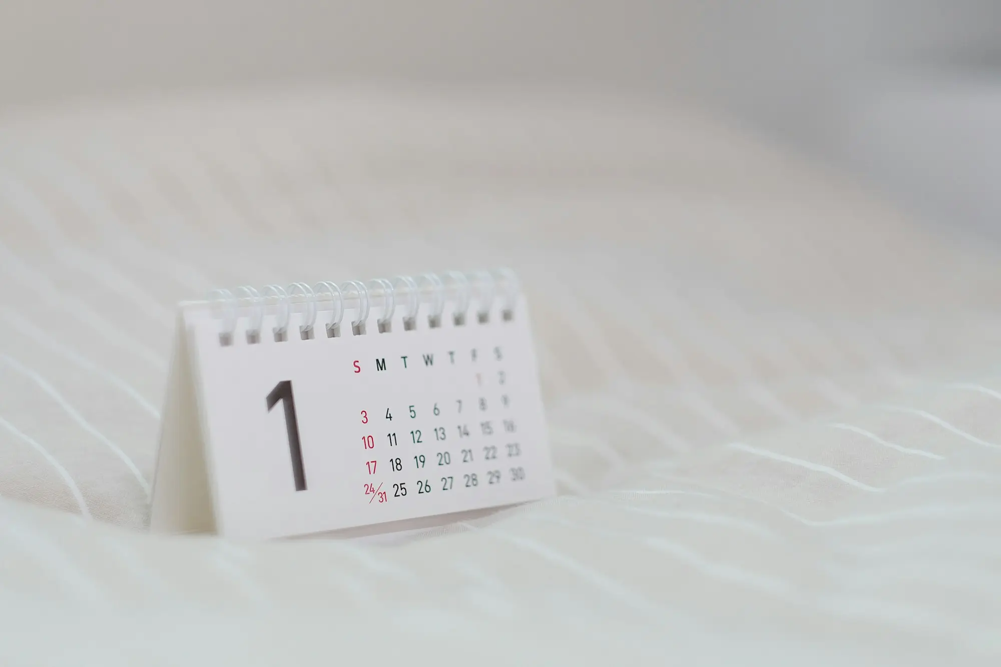 Owner marking repayment dates on a wall calendar in a small business office
